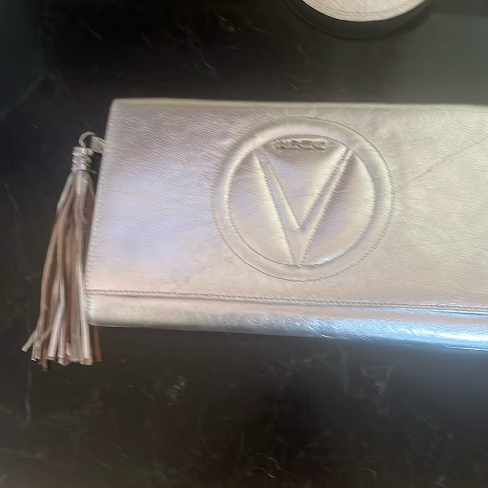 Silver Valentino clutch with cross body strap included 12 x 7 x2 inside zipper